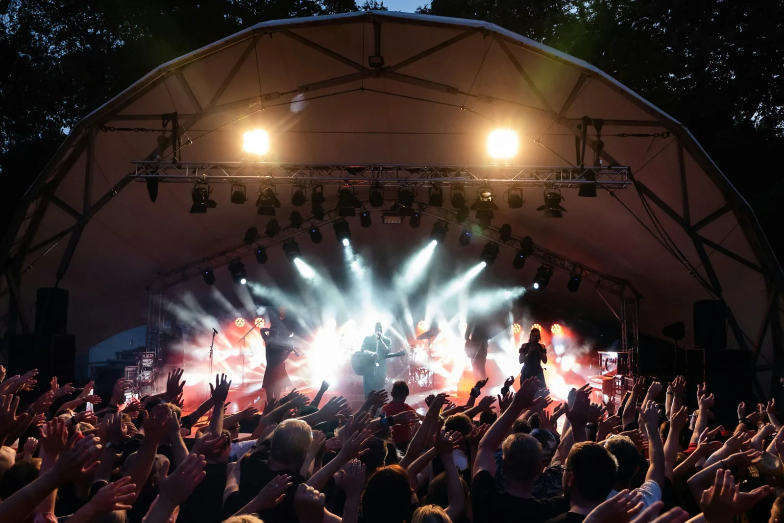 Scène de festival éclairée à la nuit tombée